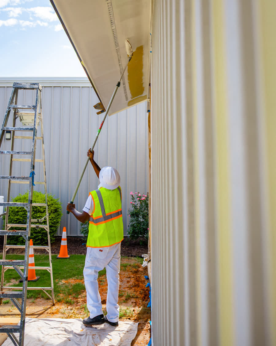 Painter working on a commercial building exterior